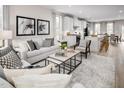 Open concept living room and kitchen. Neutral decor and hardwood floors at 1226 Helms St, Durham, NC 27713