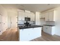 Modern kitchen featuring white cabinets, a large island, and stainless steel appliances at 1633 Wendell Valley Blvd, Wendell, NC 27591