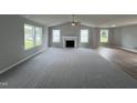 Spacious living room with gray carpet, fireplace and hardwood floors at 56 Oakfield Trace Dr, Four Oaks, NC 27524