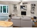 Virtually staged living room with white brick fireplace at 4808 Connell Dr, Raleigh, NC 27612