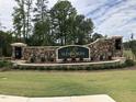 Stone entrance sign for the Ellsworth community with landscaping and lighting at 107 Ludbrook Ct, Apex, NC 27523