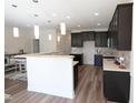 Modern kitchen with dark cabinetry, island, and stainless steel appliances at 1055 Talisker Way # 19, Burlington, NC 27215