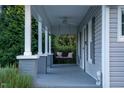 Inviting front porch features a ceiling fan and porch swing, perfect for relaxing outdoors at 119 Ferris St, Haw River, NC 27258