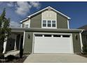 Two story green house with white garage door at 146 Swain St, Clayton, NC 27527