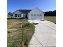 Newly built home with white siding and two-car garage at 231 Lotus Ave, Smithfield, NC 27577