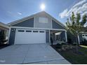 Front view of a house with a white garage door and covered carport at 177 Swain St, Clayton, NC 27527