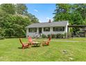 Landscaped front yard with fire pit and seating at 314 Owen St, Gibsonville, NC 27249