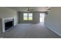Bright living room with fireplace and ceiling fan at 218 Lotus Ave, Smithfield, NC 27577
