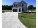 Two-story house with gray siding and attached garage at 218 Lotus Ave, Smithfield, NC 27577