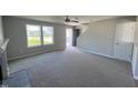 Spacious living room with carpeted floors and fireplace at 218 Lotus Ave, Smithfield, NC 27577