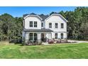 Two story white house with stone accents at 286 Duncan Creek Rd, Lillington, NC 27546