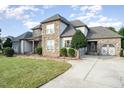 Two-story home with stone and siding, landscaping, and a spacious lawn at 2005 Shingleback Dr, Wake Forest, NC 27587