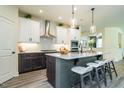 Modern kitchen with island, stainless steel appliances, and white cabinets at 741 Flower Manor Dr, Wendell, NC 27591