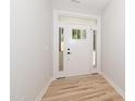 Bright entryway with white door and wood floors at 114 Shaman Dr, Louisburg, NC 27549