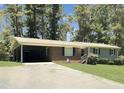 Brick ranch home with carport and a large front yard at 2400 Carbonton Rd, Sanford, NC 27330