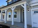 Covered front porch with white columns and gray flooring at 1013 Bostonian Dr, Knightdale, NC 27545