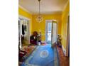 Bright living room with yellow walls and hardwood floors at 521 E Edenton St, Raleigh, NC 27601