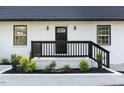 Front door with black railing and white brick at 2113 Eveton Ln, Sanford, NC 27330