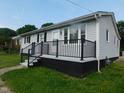 Gray house with black trim and a black metal railing at 413 Columbia Avenue Ave, Burlington, NC 27217
