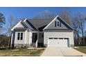 One-story house with gray siding, gray roof, and a two-car garage at 35 Courtland Dr, Louisburg, NC 27549