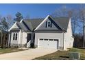 One-story house with gray siding, gray roof, and a two-car garage at 35 Courtland Dr, Louisburg, NC 27549