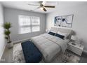 Virtually staged bedroom with a large window and neutral decor at 5107 Sandy Banks Rd, Raleigh, NC 27616