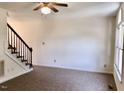 Living room with staircase and carpet at 44 Wallace St, Angier, NC 27501