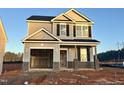 Two-story house with gray and beige siding, a brick base, and a two-car garage at 157 Greenview St, Clayton, NC 27520