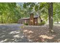 Side view of ranch home showcasing a brick chimney and attached garage at 2830 Barnett Rd, Mebane, NC 27302