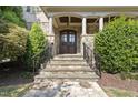 Stone steps leading to a double wooden front door with a portico at 122 Highclere Ln, Cary, NC 27518