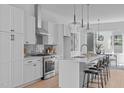 Modern kitchen with white cabinets, stainless steel appliances, and an island at 3005 Corbell Rd, Durham, NC 27701