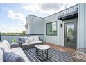 Relaxing rooftop deck features modern furniture and city views at 3005 Corbell Rd, Durham, NC 27701