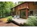 Back exterior showcasing deck and wooded area at 4416 Arrowhead Trl, Hillsborough, NC 27278