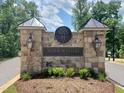 Stone entrance to Norwood Ridge community with a logo and lighting at 5828 Norwood Ridge Dr, Raleigh, NC 27614