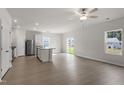 Open concept kitchen with island, stainless steel appliances, and sliding glass doors to backyard at 204 Shelfit Trl, Oxford, NC 27565