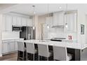 Modern kitchen with white cabinets, large island, and stainless steel appliances at 521 Impala Trce, Wendell, NC 27591