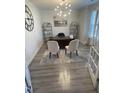 Bright home office with hardwood floors, built-in shelving, and two chairs at 5011 Manderleigh Dr, Knightdale, NC 27545