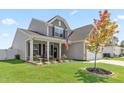 Two-story house with gray siding, porch, and American flag at 665 Brycewood Drive Dr, Burlington, NC 27215