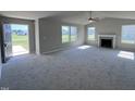 Spacious living room with a fireplace and large windows at 98 Lotus Ave, Smithfield, NC 27577