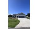 Gray house with attached garage and concrete driveway at 98 Lotus Ave, Smithfield, NC 27577