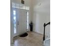 Bright entryway with tile flooring, coat closet, and staircase at 1565 Sage Treee Dr Dr, Zebulon, NC 27597