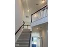 Open staircase leading to upper level with high ceilings at 1565 Sage Treee Dr Dr, Zebulon, NC 27597