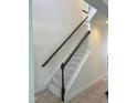 Elegant staircase with dark wood railing and neutral carpeting at 1565 Sage Treee Dr Dr, Zebulon, NC 27597