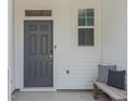 Front entrance with gray door and bench at 316 Deercroft Dr # Caroli Springs, Apex, NC 27539