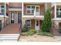 Brick townhouse exterior with steps leading to the entrance at 836 Bankston Woods Way, Raleigh, NC 27609