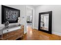Elegant entryway with hardwood floors, mirror, and antique dresser at 620 Wade Ave # 301, Raleigh, NC 27605