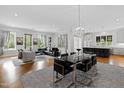 Open concept living and dining area with hardwood floors, modern furniture, and chandelier at 620 Wade Ave # 301, Raleigh, NC 27605