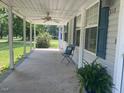 Covered front porch with seating and a view of the yard at 910 Vanco Mill Rd, Henderson, NC 27537