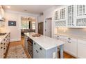 Kitchen with white cabinets, an island, and hardwood floors at 209 E Whitaker Mill Rd, Raleigh, NC 27608