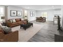 Open living room featuring hardwood floors, neutral color palette, and ample natural light at 290 Gianna Dr, Lillington, NC 27546